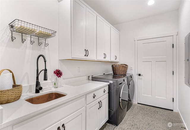 washroom featuring independent washer and dryer, cabinets, and sink