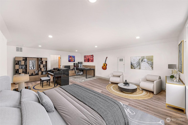 bedroom featuring baseboards, visible vents, recessed lighting, and wood finished floors