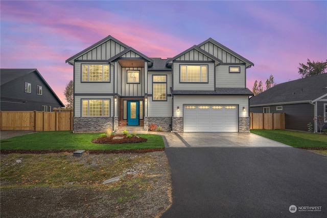 view of front of property featuring a garage and a lawn