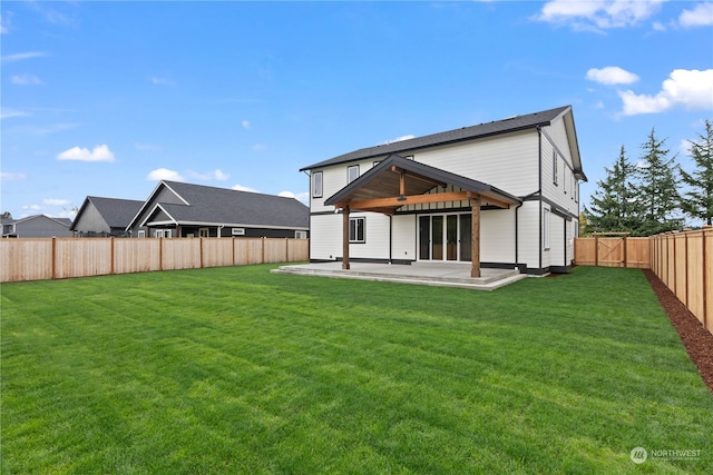 back of house with a patio, ceiling fan, and a yard