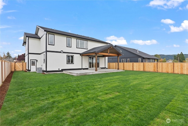 back of house with a yard and a patio area