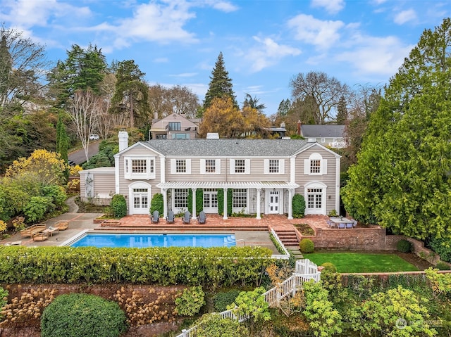 rear view of property featuring a patio area