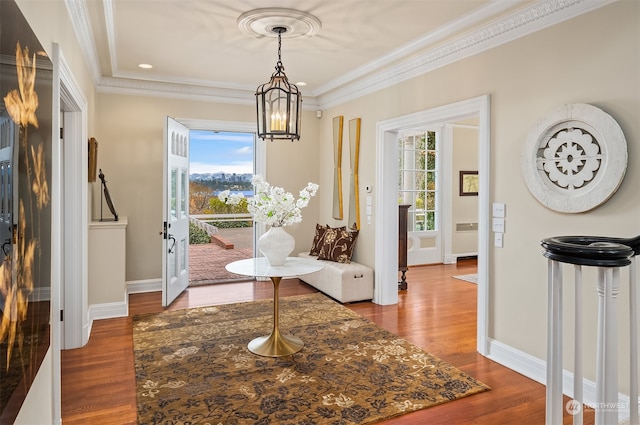 interior space featuring a chandelier, ornamental molding, and hardwood / wood-style flooring