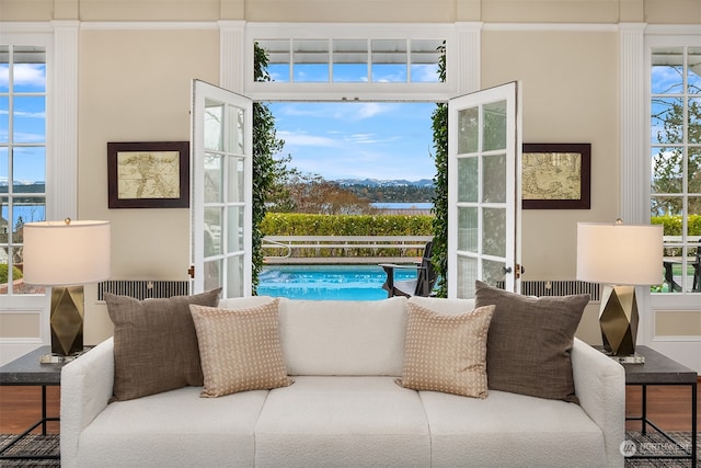 interior space featuring hardwood / wood-style flooring, a water view, and a wealth of natural light