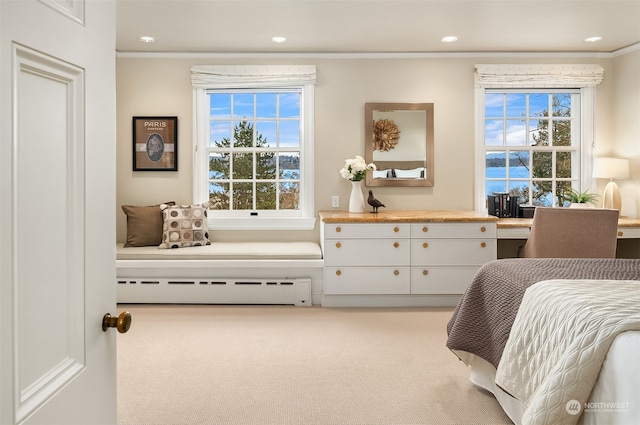 bedroom with crown molding, a baseboard radiator, and light carpet