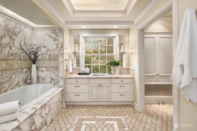 bathroom featuring tile patterned floors, vanity, a raised ceiling, crown molding, and a relaxing tiled tub