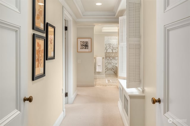 hall with light colored carpet and ornamental molding