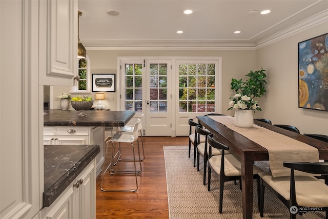 dining area with crown molding, dark hardwood / wood-style flooring, and french doors