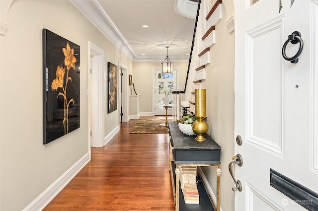 hallway with dark hardwood / wood-style flooring and crown molding