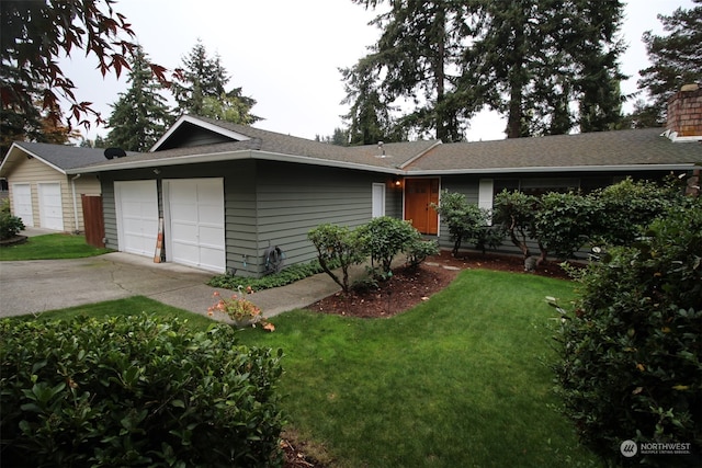 ranch-style home with a garage and a front lawn