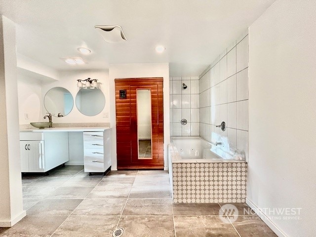 bathroom featuring a tub and vanity