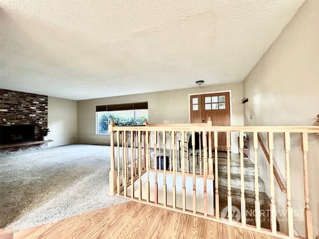 interior space with wood-type flooring and a textured ceiling