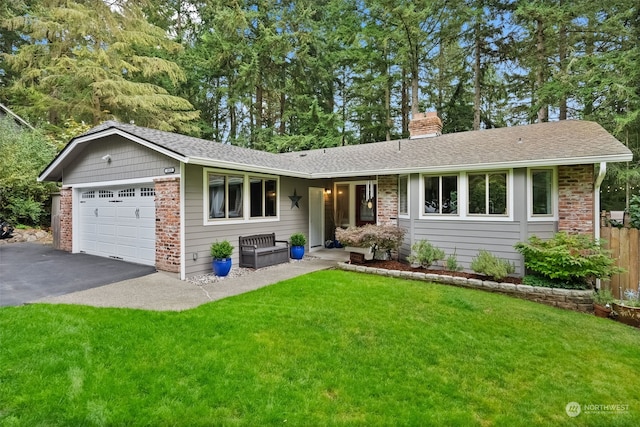 single story home featuring a front yard and a garage