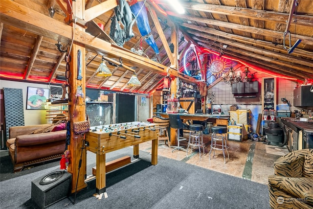 interior space with wooden ceiling, lofted ceiling with beams, and a workshop area