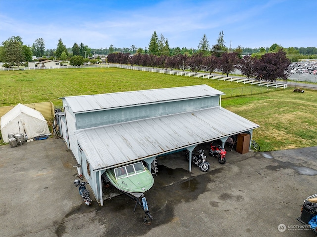 exterior space featuring a rural view and a yard