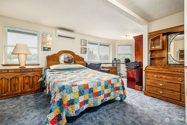 bedroom with a textured ceiling, a wall mounted AC, and dark colored carpet