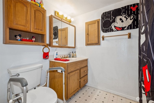 bathroom featuring toilet and vanity