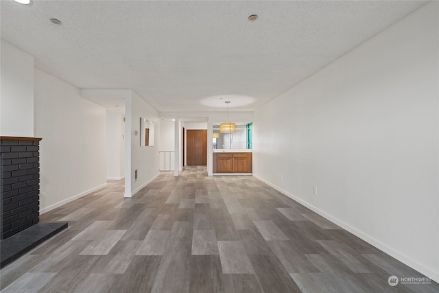 hallway featuring hardwood / wood-style flooring and a textured ceiling