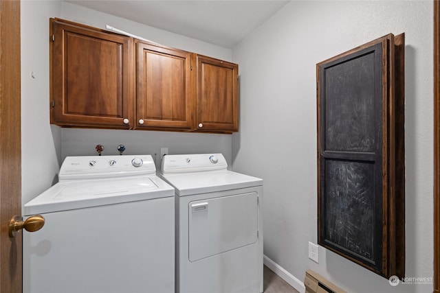 laundry room with cabinets and washing machine and clothes dryer