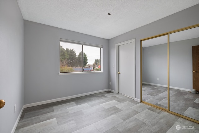 unfurnished bedroom featuring a textured ceiling