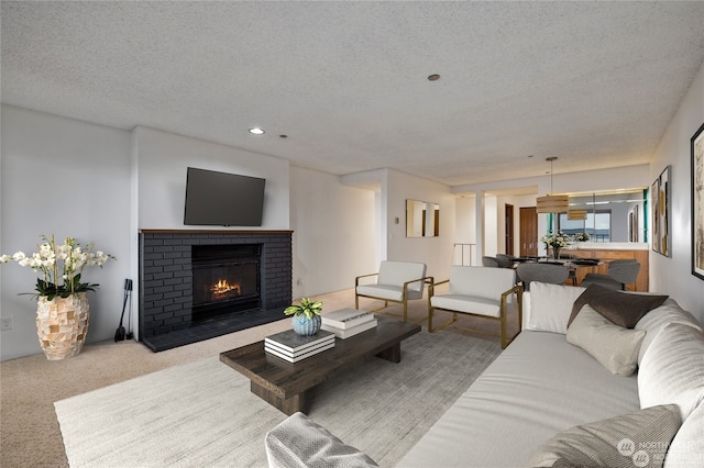 living room with a fireplace, light colored carpet, and a textured ceiling