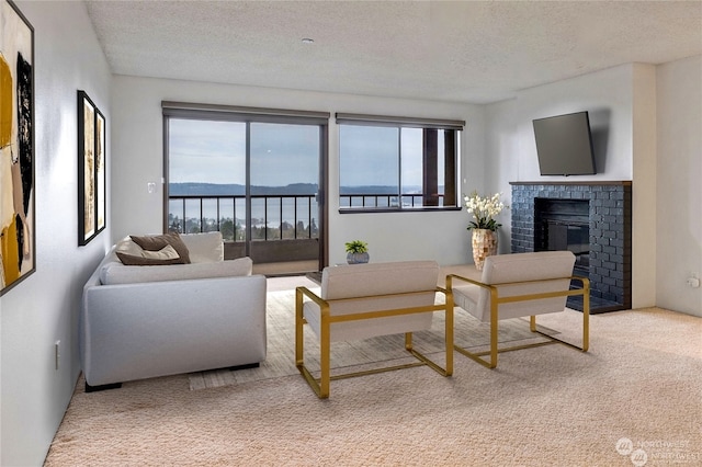 carpeted living room with a fireplace and a textured ceiling