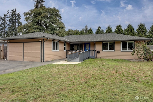 ranch-style home with a garage and a front lawn