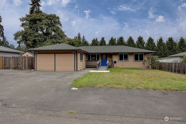 ranch-style house featuring a front yard and a garage