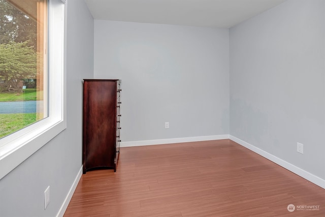 spare room with hardwood / wood-style floors