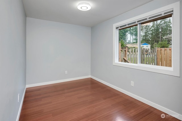 spare room with hardwood / wood-style floors