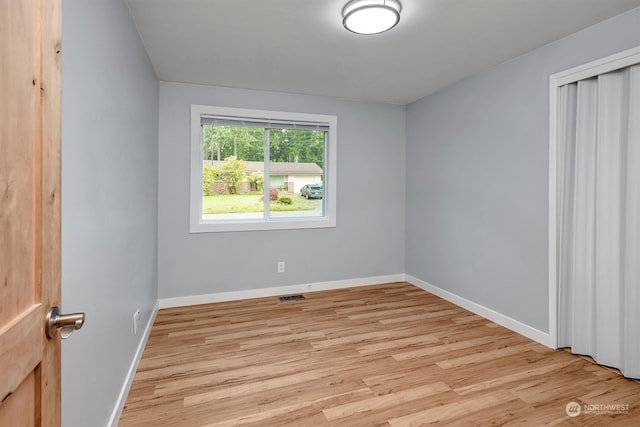 unfurnished bedroom with light wood-type flooring