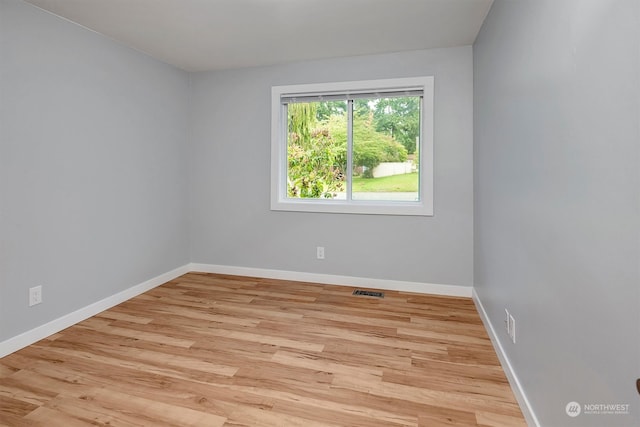 spare room featuring light hardwood / wood-style flooring