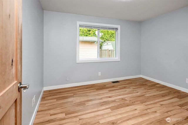 empty room with light hardwood / wood-style floors