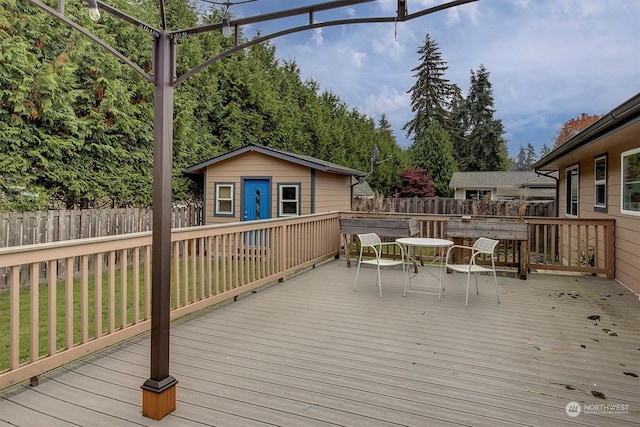 wooden terrace featuring an outbuilding