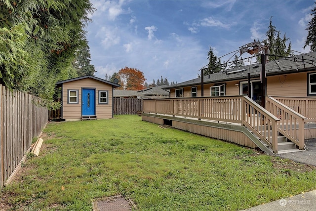 view of yard with a storage unit and a deck