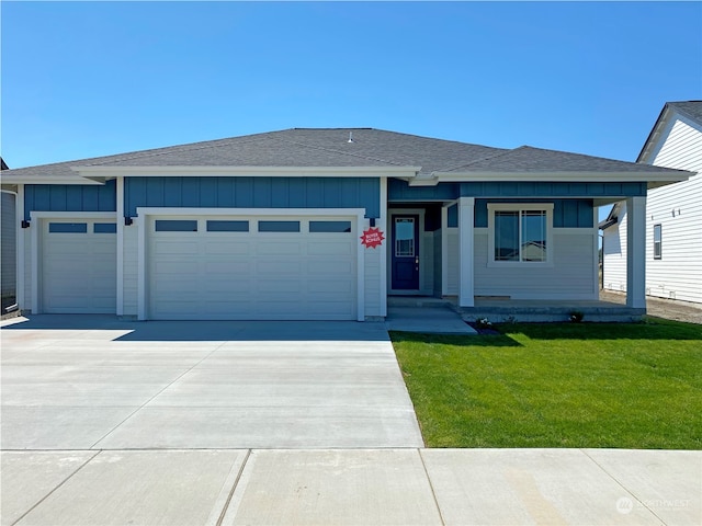 view of front facade with a front yard and a garage