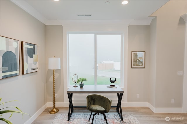 office area featuring ornamental molding and light wood-type flooring