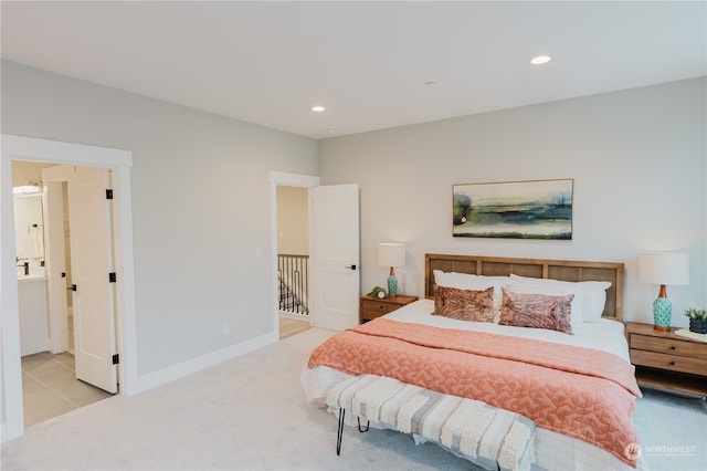 carpeted bedroom with ensuite bath