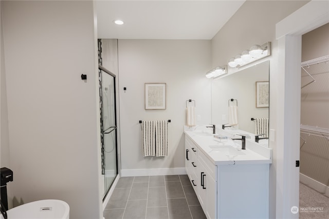 bathroom with vanity, an enclosed shower, and tile patterned floors