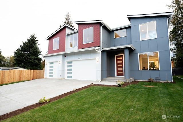 modern home with a front yard and a garage