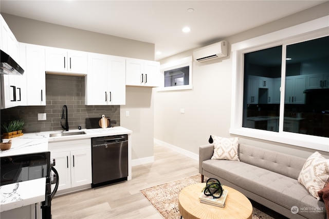 kitchen featuring white cabinets, a wall mounted AC, backsplash, black appliances, and sink