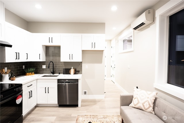 kitchen with an AC wall unit, backsplash, sink, stainless steel dishwasher, and white cabinetry