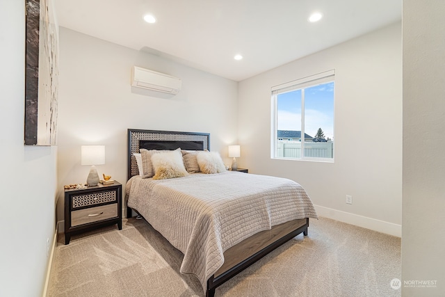 bedroom with an AC wall unit and light carpet