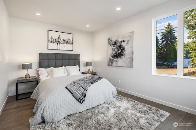 bedroom with dark hardwood / wood-style floors