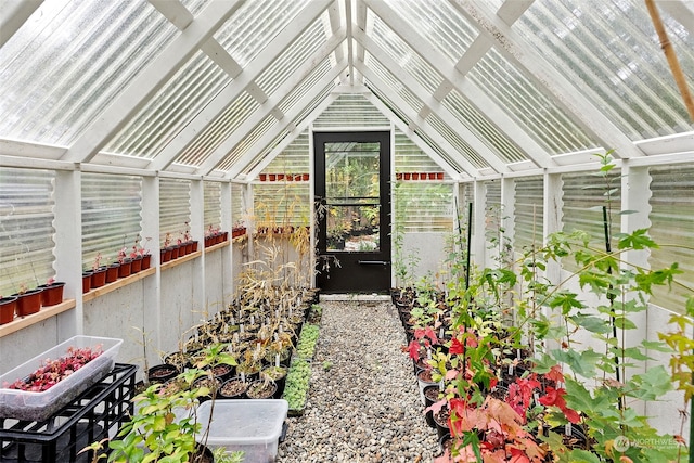 unfurnished sunroom featuring lofted ceiling