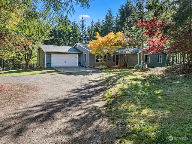 single story home with a garage and a front lawn