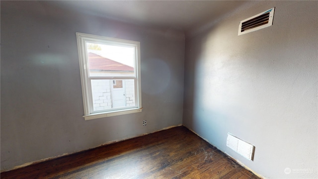 empty room with dark hardwood / wood-style flooring