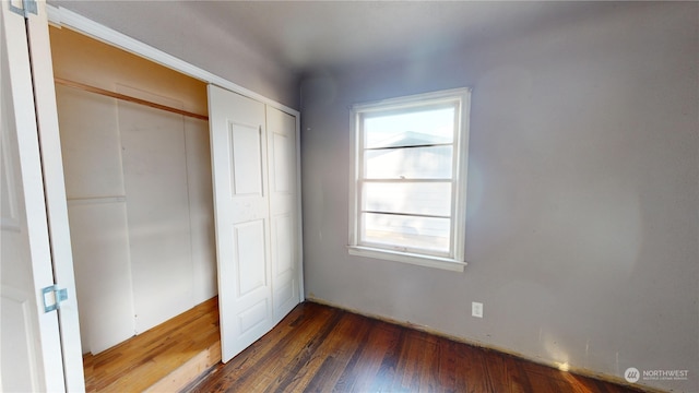 unfurnished bedroom with dark hardwood / wood-style floors