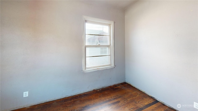 unfurnished room with dark wood-type flooring