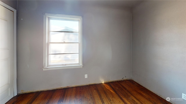 spare room featuring dark hardwood / wood-style flooring